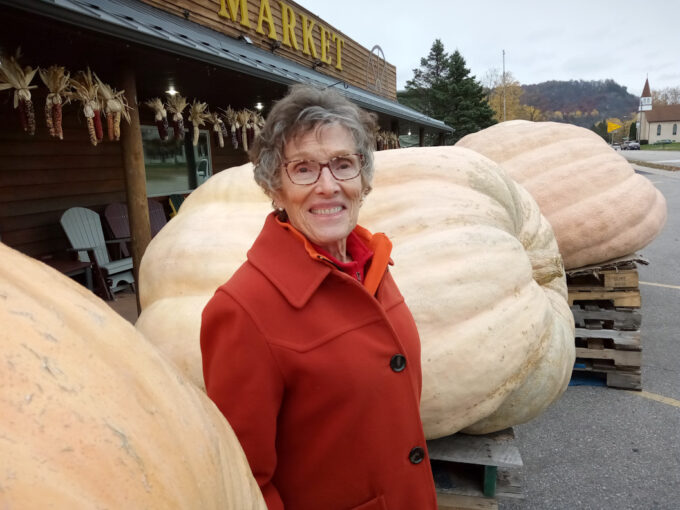 Lin standing by 2,000+ Pound Pumpkins!